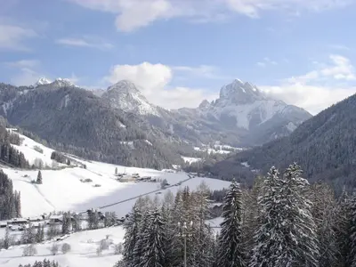 a view of a snowy mountain range with snow covered mountains at Residence Bergheim in Braies