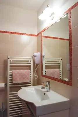 a bathroom with a sink and a mirror at Appartamenti Cesa Maria Mountain Hospitality in Canazei