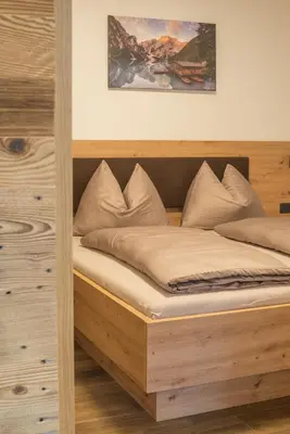 a bed in a room with a wooden frame at Jaufnerhof in Mareta