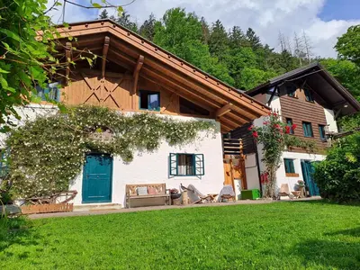a house with a blue door and a green yard at Chalet Passeier - ZOLL in Saltusio