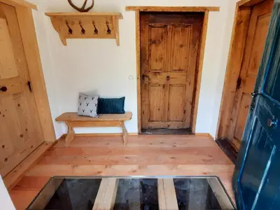 a room with wooden doors and a bench at Chalet Passeier - ZOLL in Saltusio