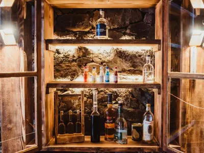 a shelf with bottles of alcohol on it at Chalet Passeier - ZOLL in Saltusio
