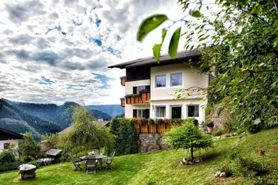 a house on a hill with a table and chairs at Villa Gottfried Appartment in Eggen
