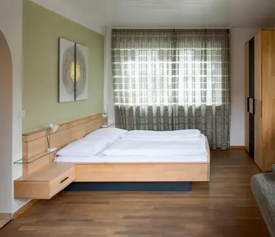 a bed in a room with a window at Villa Gottfried Appartment in Eggen