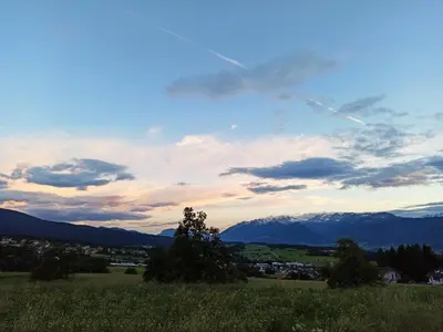 a view of a field with mountains in the background at Casa Martina in Malosco