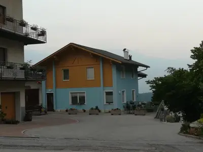 a building with a parking lot in front of it at CASA RAINA in Castelfondo