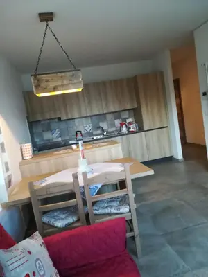 a kitchen with a table and a couch in a room at CASA RAINA in Castelfondo