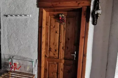 a wooden door with a christmas wreath on it at Casa Bel Vedere in Falcade