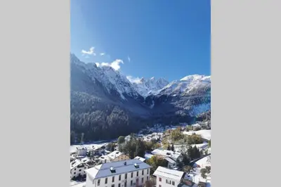 an aerial view of a town with snow covered mountains at Casa Bel Vedere in Falcade