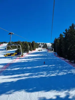 a snow covered ski slope with a ski lift at Appartamento con giardino in Predazzo