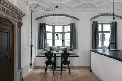 a kitchen with a table and two chairs at Ida - historic town apartments in Vipiteno