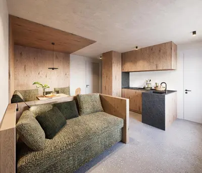 a living room with a couch and a kitchen at Ida - historic town apartments in Vipiteno