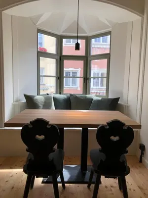 a dining room with a table and two chairs at Ida - historic town apartments in Vipiteno