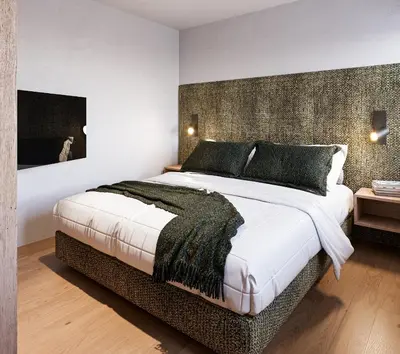 a bedroom with a large bed with a wall at Ida - historic town apartments in Vipiteno