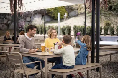 a group of people sitting at a table at a restaurant at Hotel Restaurant Putzer in Naz-Sciaves