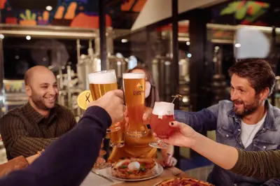 a group of people holding up glasses of beer at Hotel Restaurant Putzer in Naz-Sciaves