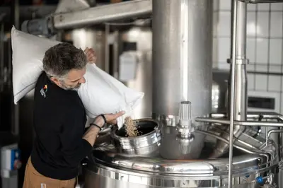 a man standing in a kitchen preparing food at Hotel Restaurant Putzer in Naz-Sciaves