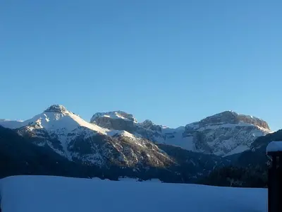 a group of mountains with snow on them at Casa Tania in Pozza di Fassa