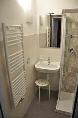 a small bathroom with a sink and a shower at Casa Tania in Pozza di Fassa