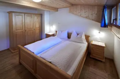 a bedroom with a large bed with two night stands at THOMASERHOF in Redagno