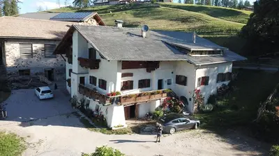 a house with a car parked in front of it at THOMASERHOF in Redagno