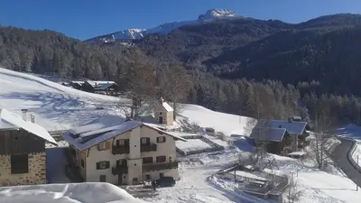 an aerial view of a house in the snow at THOMASERHOF in Redagno
