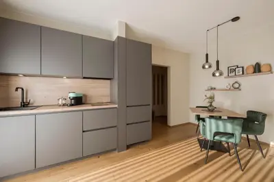 a kitchen with white cabinets and a sink at Boutique Hotel Wiesenhof - Adults Only in Lana