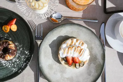 a plate of food on a table with desserts at Boutique Hotel Wiesenhof - Adults Only in Lana