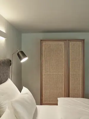 a bedroom with a bed with white pillows and a window at Parcloft in Merano