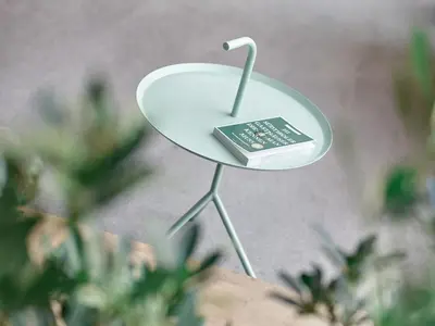 a small white table with a remote control on it at Parcloft in Merano