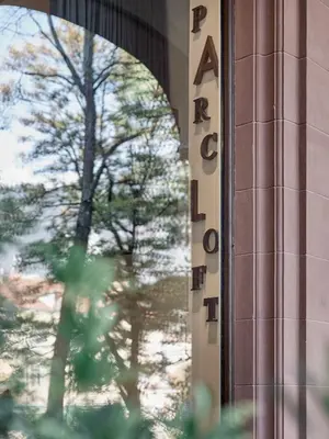 a sign on the side of a building with a tree at Parcloft in Merano