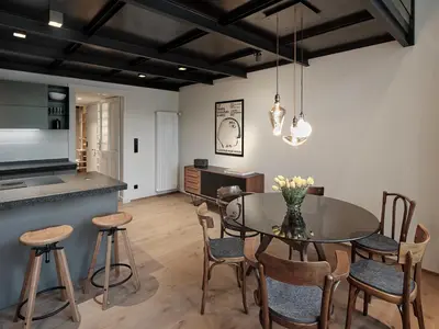 a kitchen and dining room with a glass table and chairs at Parcloft in Merano