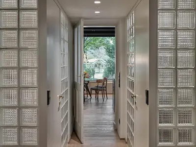 a hallway with doors leading to a dining room at Parcloft in Merano