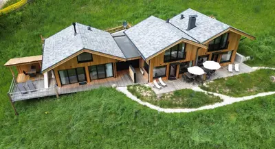 an aerial view of a log house with chairs and tables at Chalet Tschogerhof Tiers am Rosengarten Dolomiten in Tires