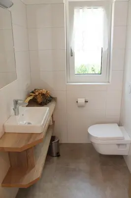 a bathroom with a sink and a toilet and a window at Garni Wiesenhof in Naturno