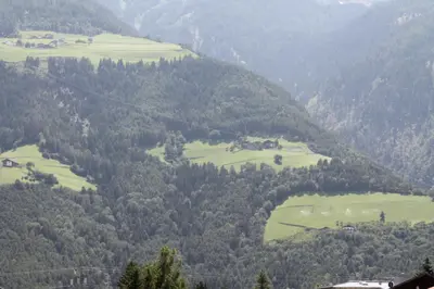a view of a valley with green fields and trees at Garni Wiesenhof in Naturno