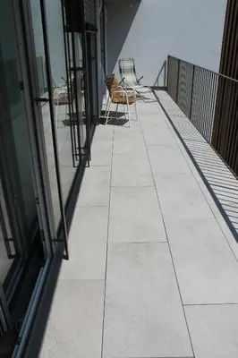 a balcony with chairs and tables on a building at Garni Wiesenhof in Naturno