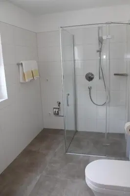a bathroom with a glass shower and a toilet at Garni Wiesenhof in Naturno