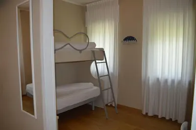 a small room with a bunk bed and a ladder at Park Hotel Sancelso in Bellamonte