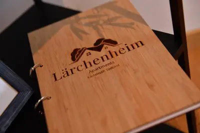 a wooden sign on a table with the words lader differentiation at Lärchenheim Appartment in Castelrotto