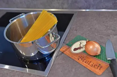 a container with a pot of pasta on a counter at Lärchenheim Appartment in Castelrotto