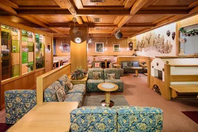 a waiting room with couches and a bus at Hotel Coldai in Alleghe