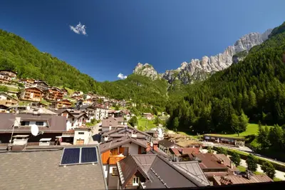 a view of a town in the mountains at Hotel Coldai in Alleghe
