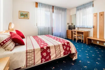 a hotel room with a bed and a desk at Hotel Coldai in Alleghe