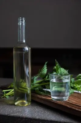 a bottle of oil next to a glass of water at Ansitz Lidl in Tesimo