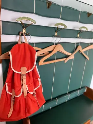 a red purse is hanging on a rack at Villa Maria Dolomites Vintage Home in Brunico