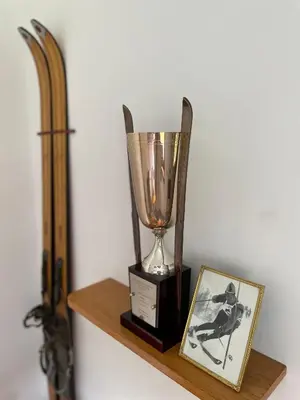 a trophy on a wooden shelf next to a picture at Villa Maria Dolomites Vintage Home in Brunico