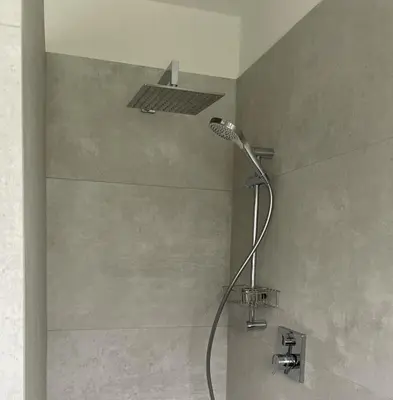a shower with a shower head in a bathroom at Villa Maria Dolomites Vintage Home in Brunico