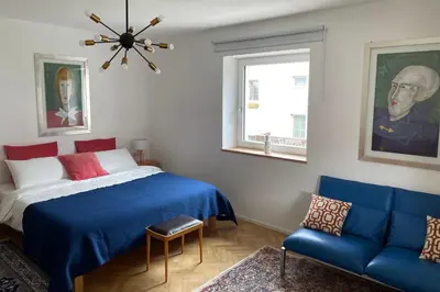 a bedroom with a blue bed and a blue couch at Villa Maria Dolomites Vintage Home in Brunico