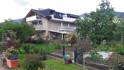 a house with a garden in front of it at Ausserdorfer Apartments in Lana